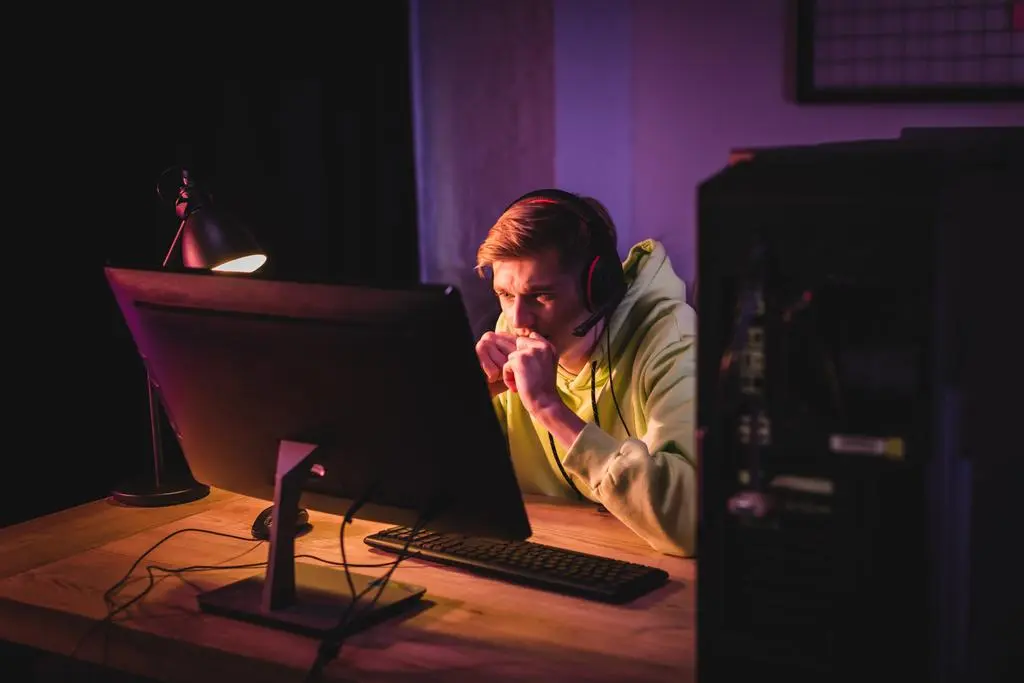 stock photo tensed gamer headset looking computer