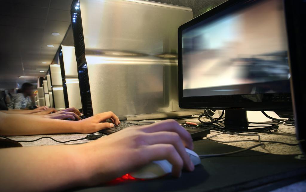 stock photo computer gaming at internet cafe